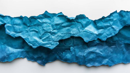 Blue crumpled paper layers forming a wavy, textured landscape.