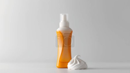Sunscreen bottle with a pump and a dollop of cream against a clean, white background.