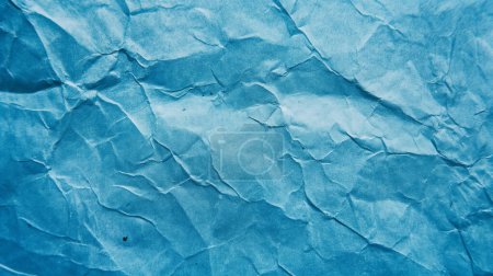 Textured blue surface with a pattern reminiscent of cracked ice or dry earth.