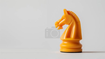 Yellow knight chess piece on a white background, the embodiment of strategy and intelligence in the game.