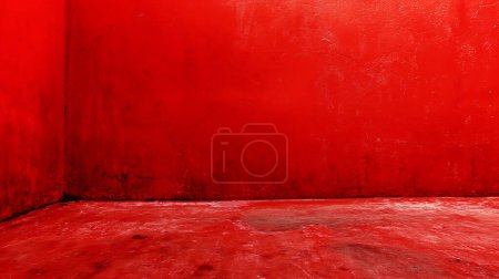 Foto de Esquina pintada de rojo intenso de una habitación con paredes texturizadas y suelo, evocando una declaración audaz. - Imagen libre de derechos