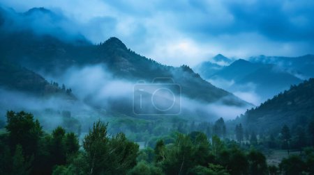 Mystical landscape of misty mountains enveloped in low-hanging clouds with lush green forests under a blue twilight sky.