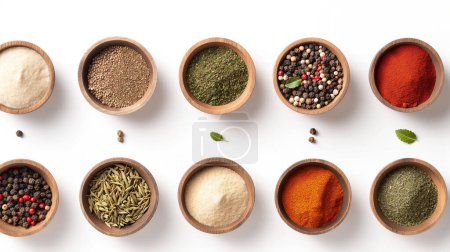 Assorted spices and herbs neatly arranged in wooden bowls on a white background, showcasing variety and vibrant colors.