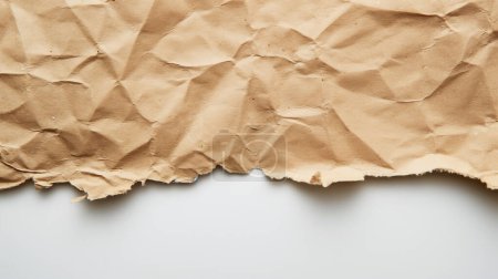 Photo for Torn and crumpled brown paper with a textured surface, depicted against a plain white background, highlighting its rough and uneven edges. - Royalty Free Image