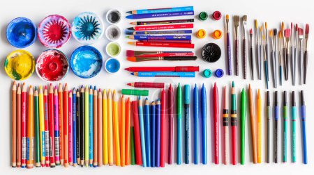 A vibrant assortment of art supplies arranged neatly, including colorful paint cups, pencils, brushes, and markers, showcasing a variety of creative tools on a white background.
