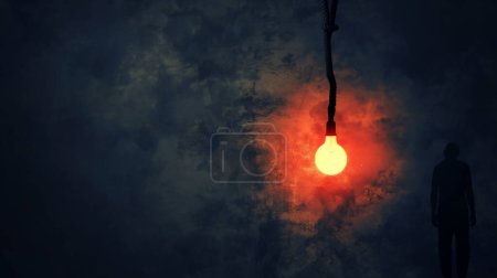 Silhouette of a man facing a glowing light bulb in a dark, misty setting.