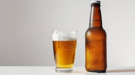 Téléchargez les photos : Chilled beer in a glass and bottle with condensation, on a neutral background. - en image libre de droit