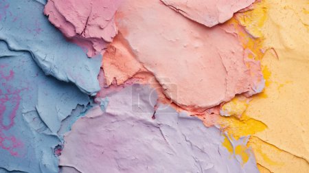 Pastel-colored clay in blue, pink, peach, lavender, and yellow, smeared and textured, creating an abstract and artistic background.