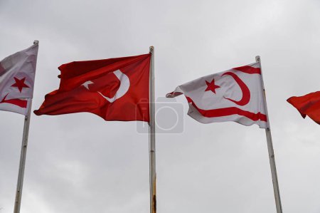 flag of Turkey and Northern Cyprus against the background of a cloudy sky in winter 2