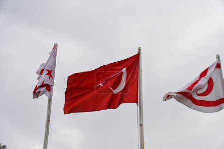 flag of Turkey and Northern Cyprus against the background of a cloudy sky in winter