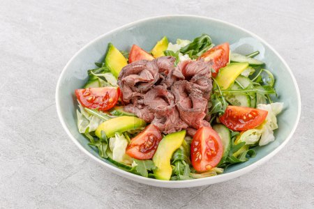 Salad with roast beef, avocado and tomatoes on a stone background studio food photo 8