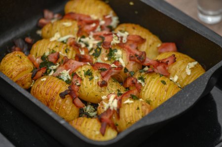 baked potatoes with bacon in the kitchen