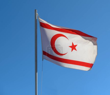 flag of the Turkish Republic of Northern Cyprus against a blue sky