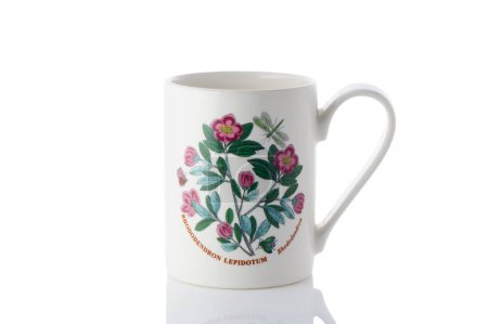 cup with a flower painted on it on a white background. Isolate 1