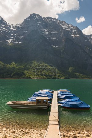 Téléchargez les photos : Jetée et bateaux au bord du lac Kloentalersee, Kloental, Alpes Glaris, canton de Glarus, Suisse - en image libre de droit