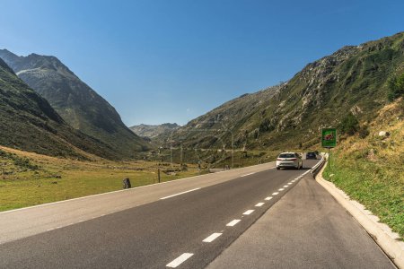Photo for Hospental, Canton of Uri, Switzerland - August 19, 2023. Cars driving on a mountain road from Hospental towards the top of Gotthard Pass. - Royalty Free Image