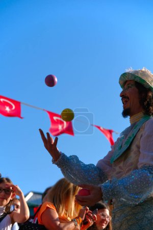 Photo for Tekirdag, Turkey - June 11, 2023: Juggler show during cortege walk on cherry festival event - Royalty Free Image