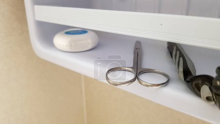 Photo for Dental floss, scissor and razor in bathroom - Royalty Free Image