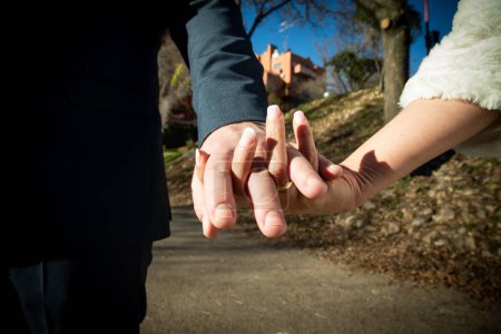 Photo for Bride and groom holding hands on wedding day - Royalty Free Image