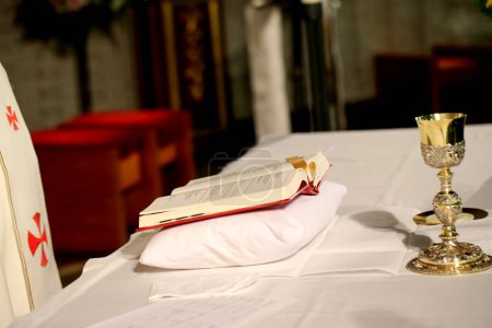 Photo for Holy bible and golden cup on the table in church - Royalty Free Image