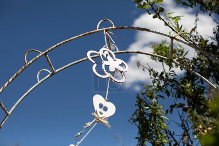 Photo for Beautiful hanging heart decoration against blue sky - Royalty Free Image