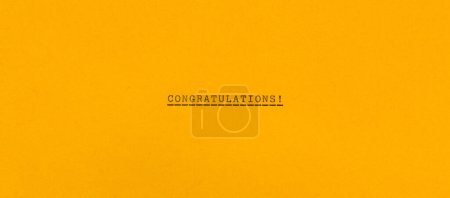 Foto de Congratulations! on horizontal yellow paper - Imagen libre de derechos