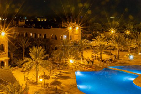 Photo for Kasbah-Hotel Chergui. Pool and garden of a maroccan kasbah hotel at night, Maroc, Africa. - Royalty Free Image