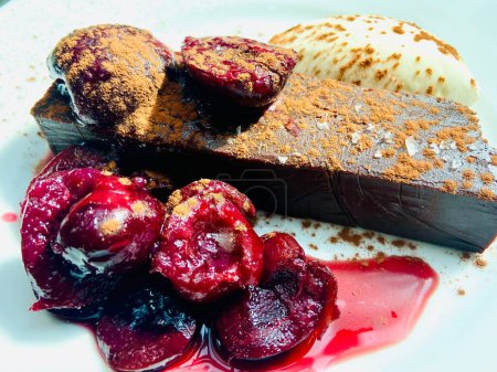 Photo for Chocolate Grenache dessert cherries cream crme Freche fraich on plate with coco powder and salt - Royalty Free Image