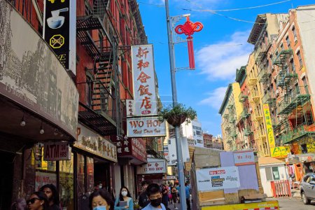 Photo for New York, NY, USA - Nov 8, 2022: A multitude of signs in both English and Chinese are shown along Mott Street in NYC Chinatown - Royalty Free Image