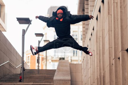 fashionable hip hop breakdance artist performer jumping with open arms - urban lifestyle concept
