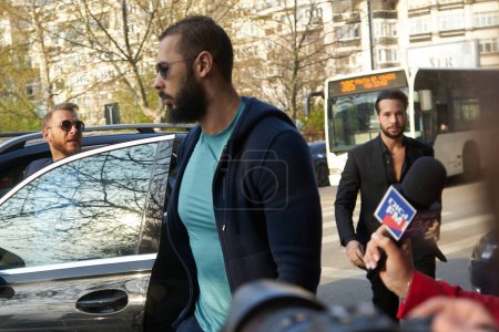 Photo for Bucharest, Romania. 10th Apr, 2023: Andrew Tate (C) and his brother Tristan Tate (R) arrive at the Directorate for Investigating Organized Crime and Terrorism DIICOT - Royalty Free Image