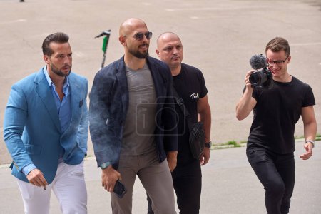 Photo for Bucharest, Romania. 8th May, 2024: Andrew Tate (C-L) and his brother Tristan Tate (L), accompanied by a cameraman who came with them, arrive at the Bucharest Court. - Royalty Free Image