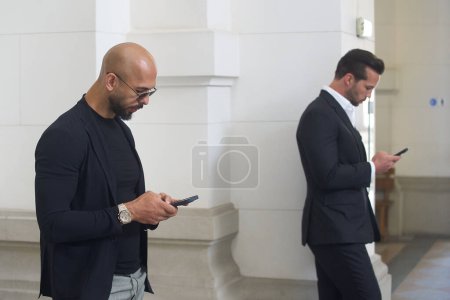 Photo for Bucharest, Romania. 30th May, 2024: Andrew Tate (L) and his brother Tristan Tate (R) wait to enter the courtroom at the Bucharest Court of Appeal. - Royalty Free Image