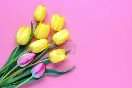 Photo for Bouquet of yellow tulips on pink background Top view Flat lay Holiday greeting card Happy moter's day, 8 March, Valentine's day, Easter concept Copy space Mock up. - Royalty Free Image