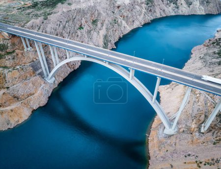 Photo for Aerial panoramic view with Maslenica bridge - a deck arch bridge near town of Zadar in Croatia with beautiful clouds and vibrant sea - Royalty Free Image