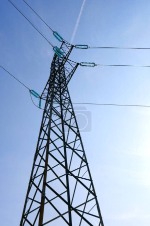 HIgh voltage transmission network silhouette over the sky. Electricity pylon. High quality photo