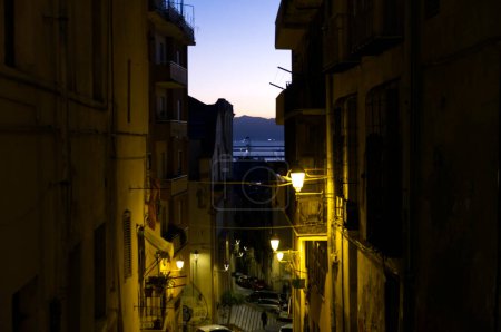 disparo nocturno de los callejones de Cagliari y en el fondo el golfo al atardecer. Foto de alta calidad