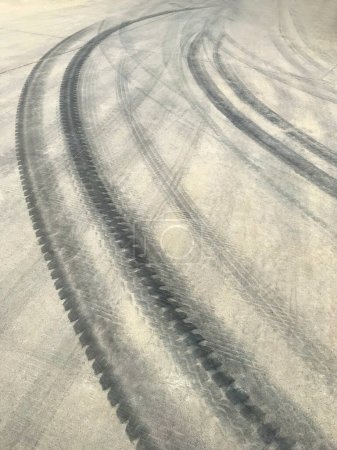 Photo for Traces of car tires on the road - Royalty Free Image