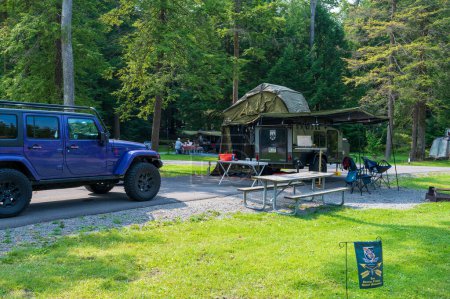 Photo for Cooksburg PA - September 17, 2022: Small teardrop travel trailer parked at a state campground site. High quality photo - Royalty Free Image