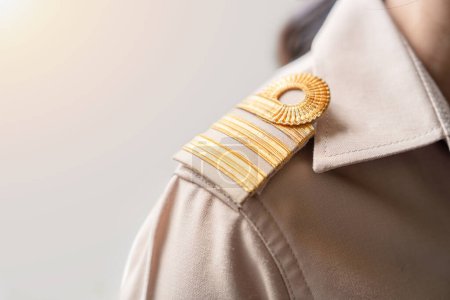 Photo for Photo of a brown uniform with a gold stripe on the shoulder, Thai civil servant uniform. - Royalty Free Image