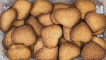 Photo for Homemade and handmade heart shaped cookies just baked, view overhead. - Royalty Free Image