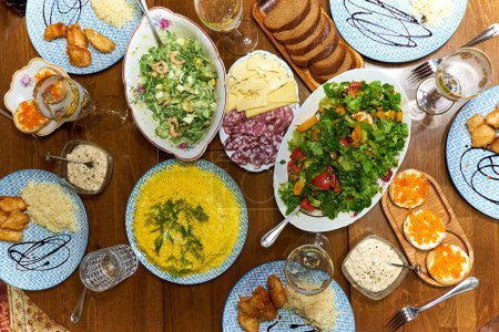 Foto de Una cena, una mesa llena de una variedad de platos para los huéspedes.. - Imagen libre de derechos