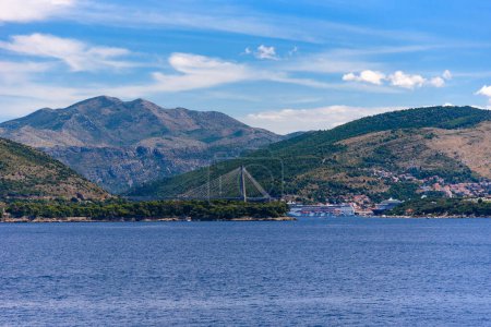 Photo for Suspension bridge - Frank Tudman's Bridge - over the water towards the famous croatian coastal town of Dubrovnik, Croatia - Royalty Free Image