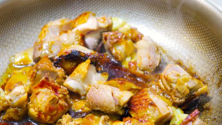 Stir -fried tender chicken pieces in a close -up pot