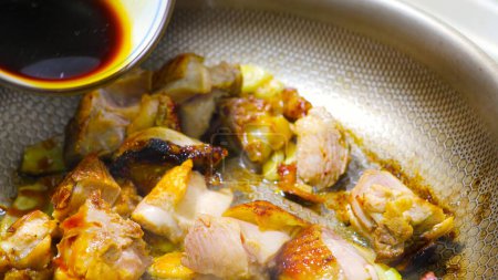 Stir -fried tender chicken pieces in a close -up pot