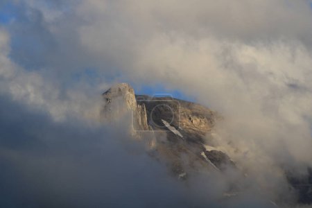 Téléchargez les photos : Peak of Mount Gstellihore visible trough a window in the clouds. - en image libre de droit