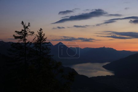 Photo for Lake Thun and pyramid shaped mountain Niesen and outlines of spruces, Switzerland. - Royalty Free Image