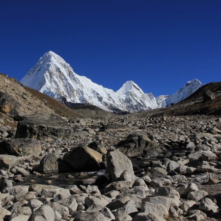 Photo for Stony trail of the Everest Base Camp Trek and snow covered Mount Pumori, Nepal. - Royalty Free Image