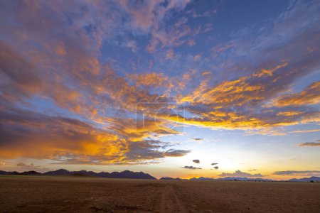Pink and orange colored clouds after sunset Namibia