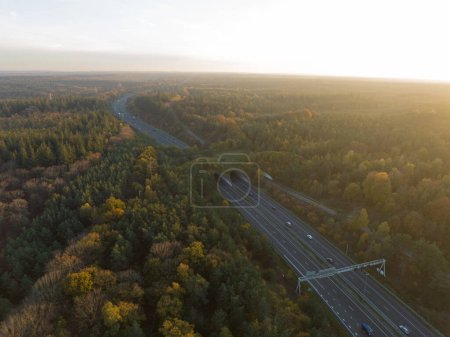Photo for Ecoduct, ecopassage, nature bridge or game changeover. Infrastructure structure for animals and other wildlife to cross traffic, passage over a highway. Nature and man made objects merge. Aerial - Royalty Free Image